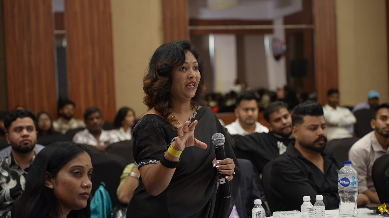 Attendee asking a question at an ixiiy event